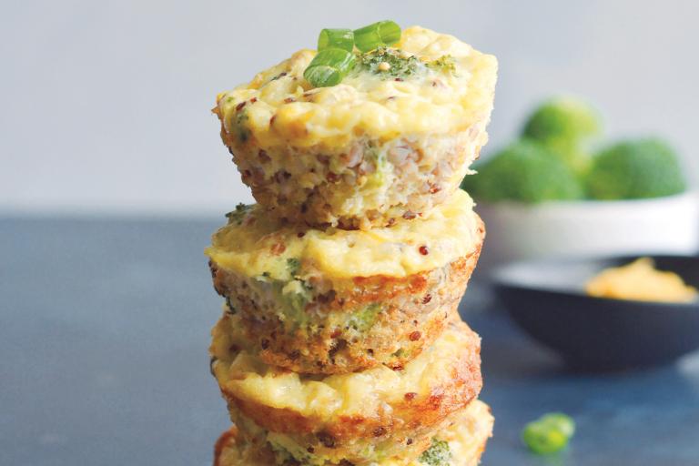 Cheesy Broccoli Quinoa Eggs Muffins stacked like a tower.